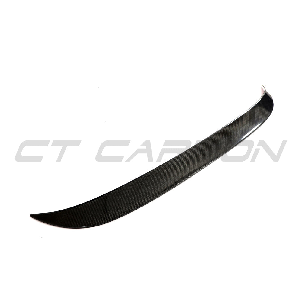 Hyundai i30N carbon fiber spoiler by CT Design, showcasing sleek aerodynamic design and textured carbon fiber surface.