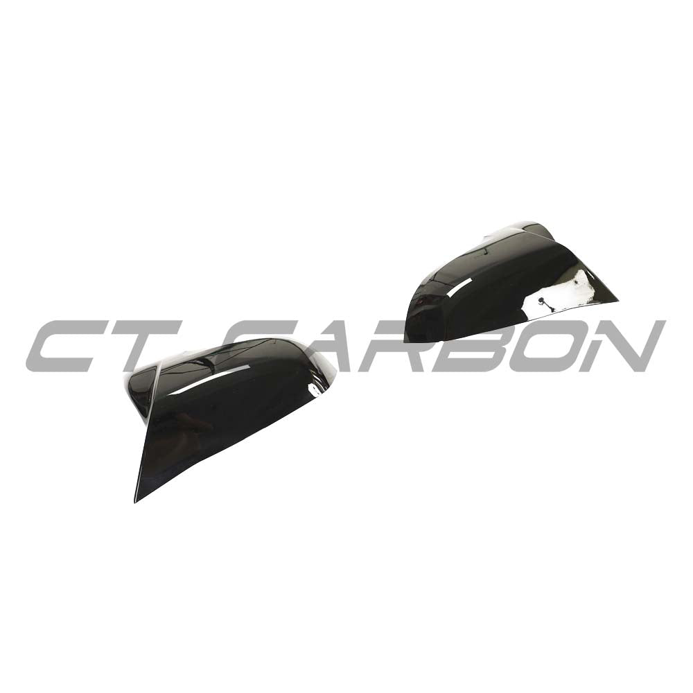 BMW F40/F44 1 & 2 Series CT Carbon gloss black mirror covers installed on side mirrors, showcasing sleek accessory design.