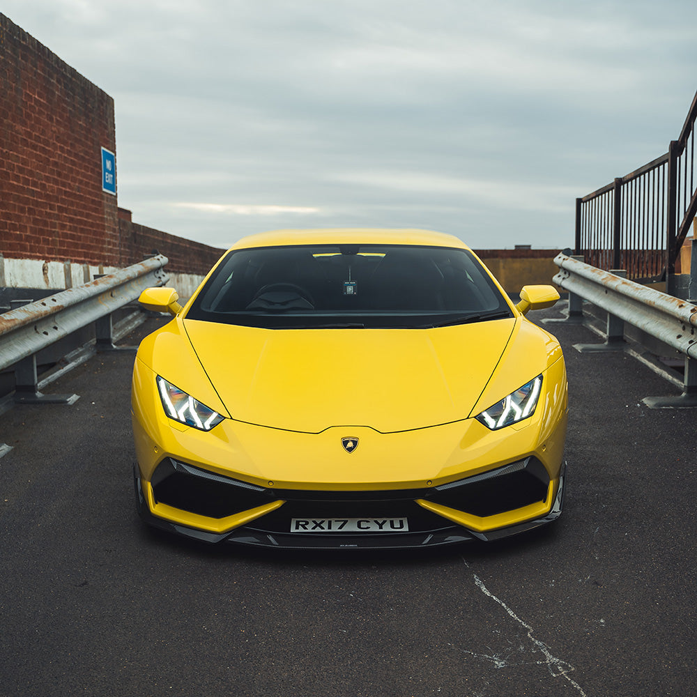 Lamborghini Huracan LP-610 carbon fiber front bumper trim accessory by CT Design, showcasing sleek, textured carbon fiber detail.