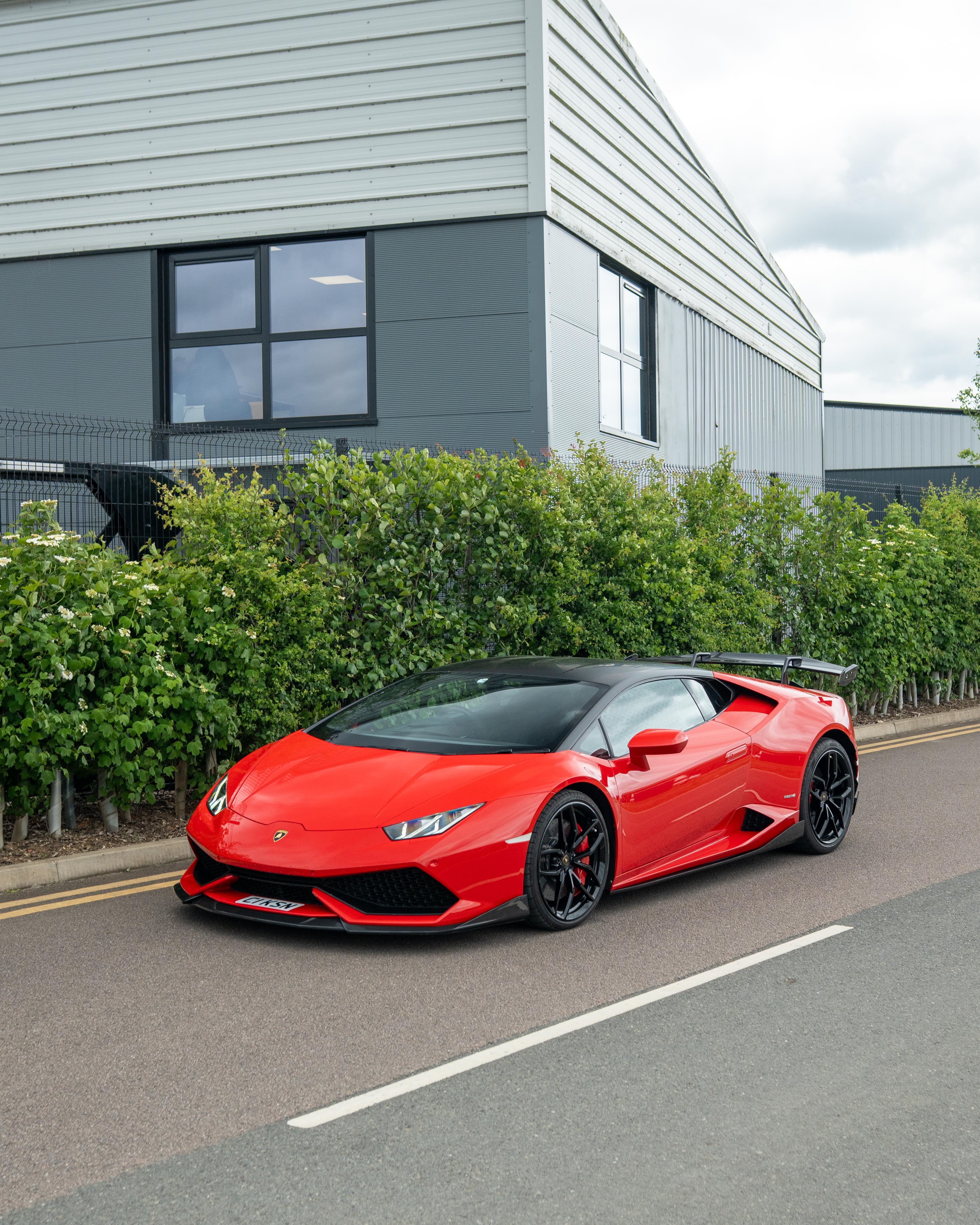Lamborghini Huracan LP-610 carbon fibre splitter by CT Design, front view showing aerodynamic design and carbon fibre texture.