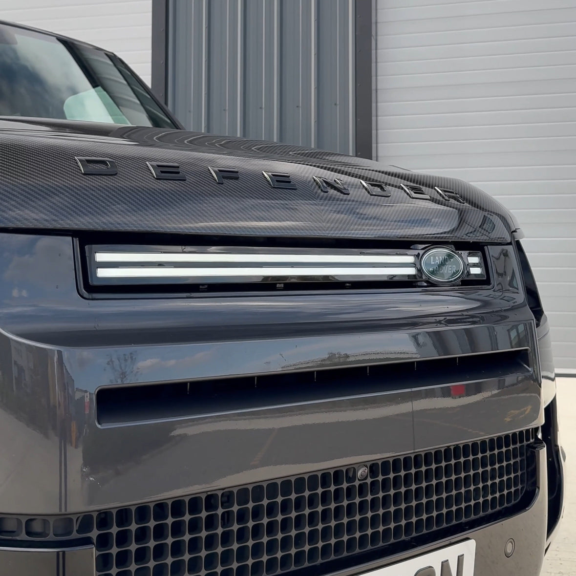 Land Rover Defender L663 110 and 90 front grille LED light by CT Carbon, showcasing the sleek LED lighting installed on the grille.