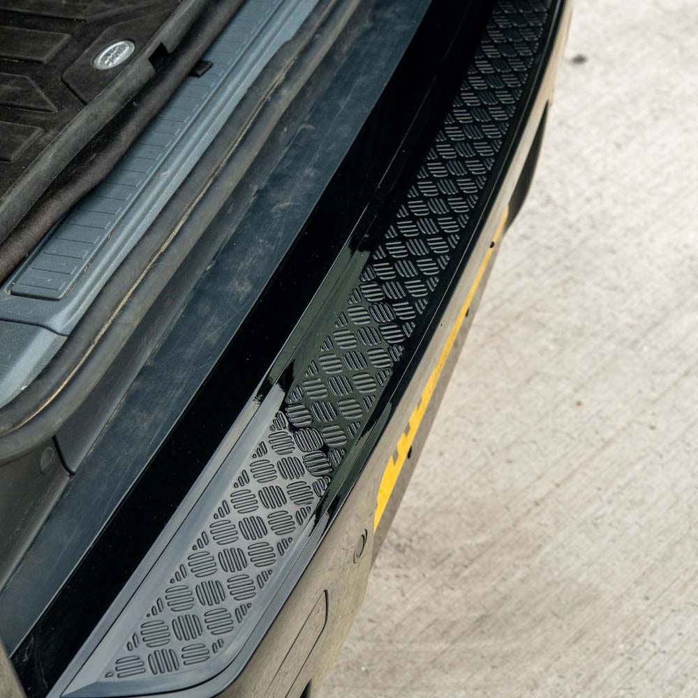 Gloss black anti-scratch trim set for Land Rover Defender L663 110 by CT Carbon, shown on vehicle body with close-up of trim details.