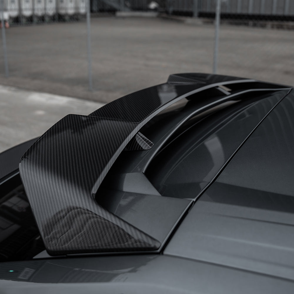 Lamborghini Urus carbon fibre roof spoiler by CT Carbon, showcasing sleek, aerodynamic design on the vehicle's roof.