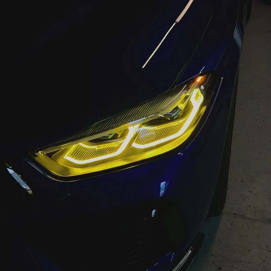 BMW M8 F91/F92/F93 2019-2023 CT Carbon yellow adaptive DRL module set installed on front of vehicle.