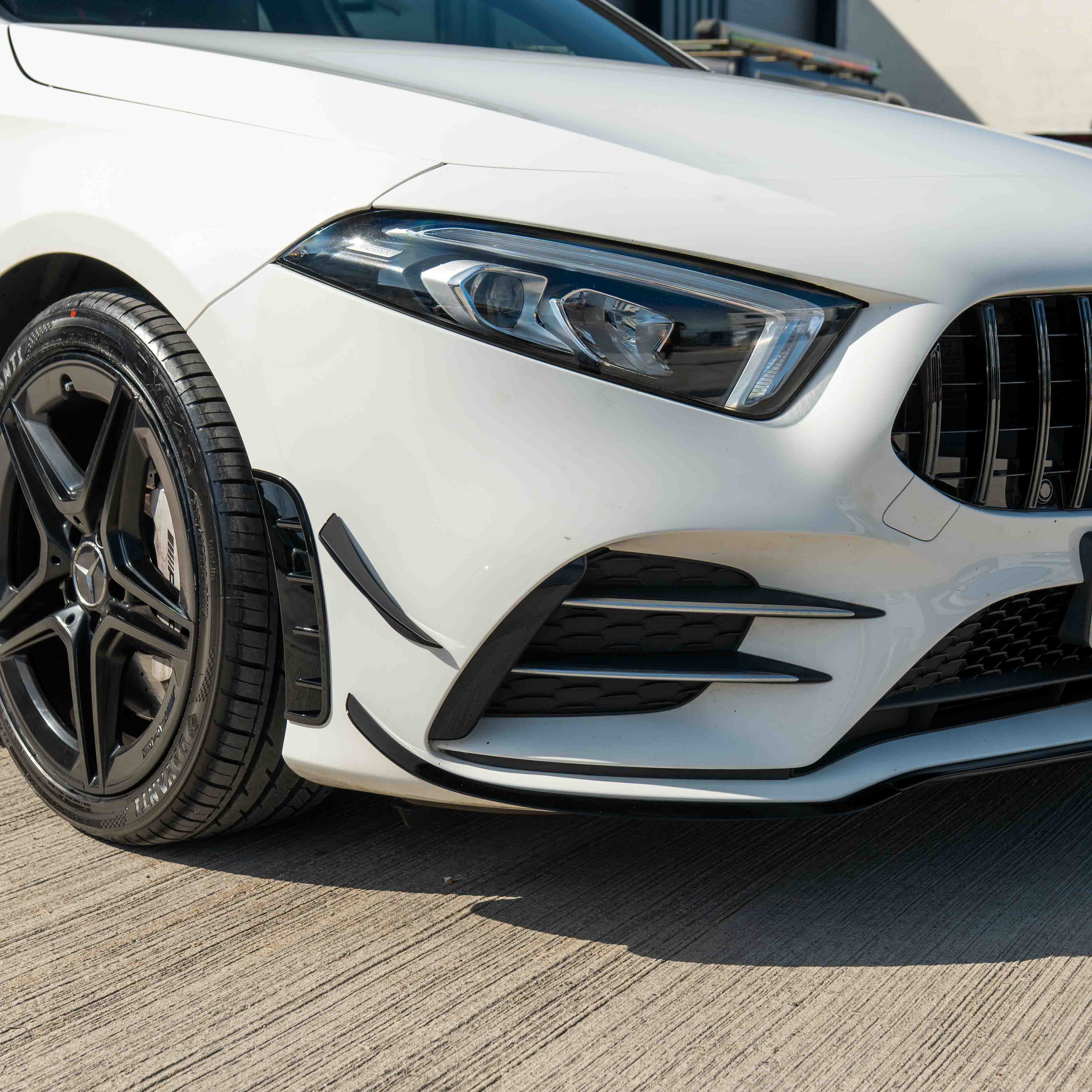 Mercedes A-Class V177 W177 2018-2022 CT Carbon gloss black splitter with canards, showing the aerodynamic front bumper enhancement.