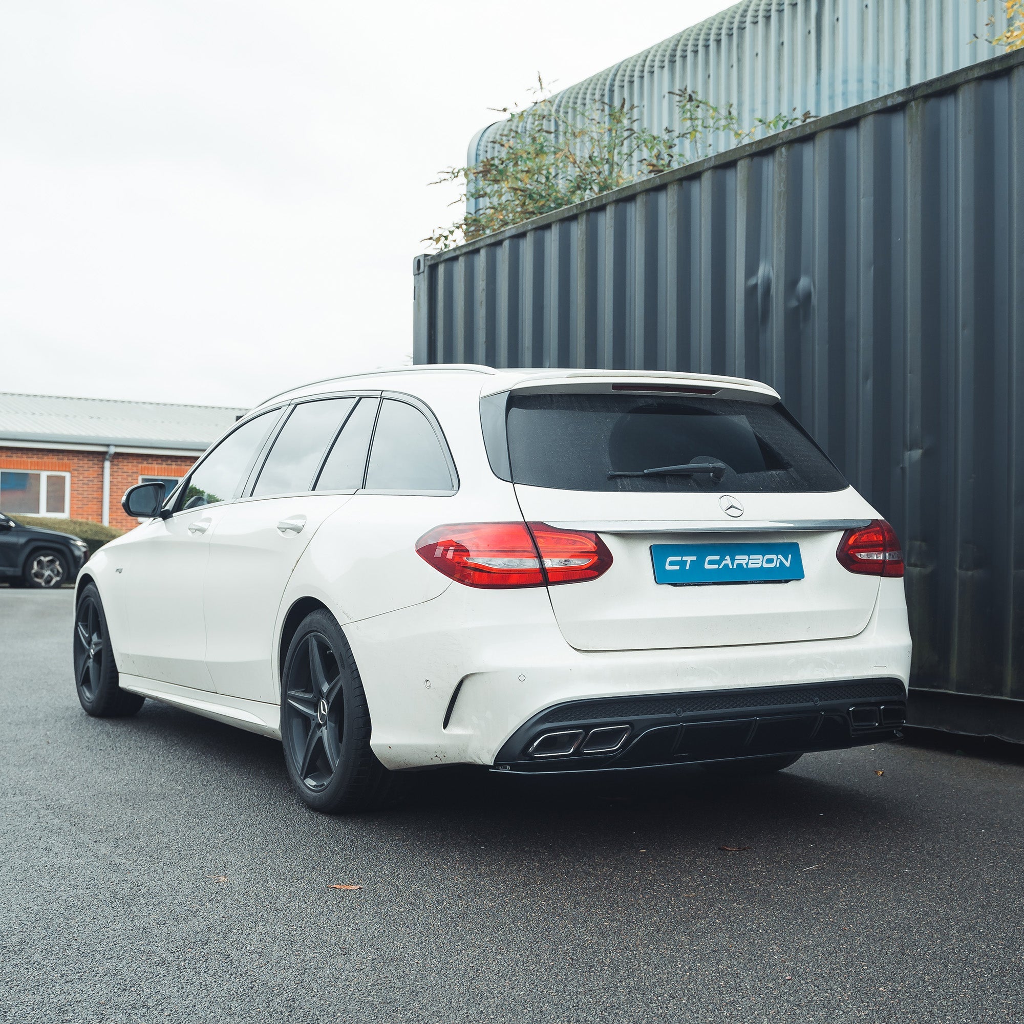 Mercedes C-Class W205 saloon estate gloss black diffuser with black tips by CT Carbon, showing the sleek rear bumper detail.