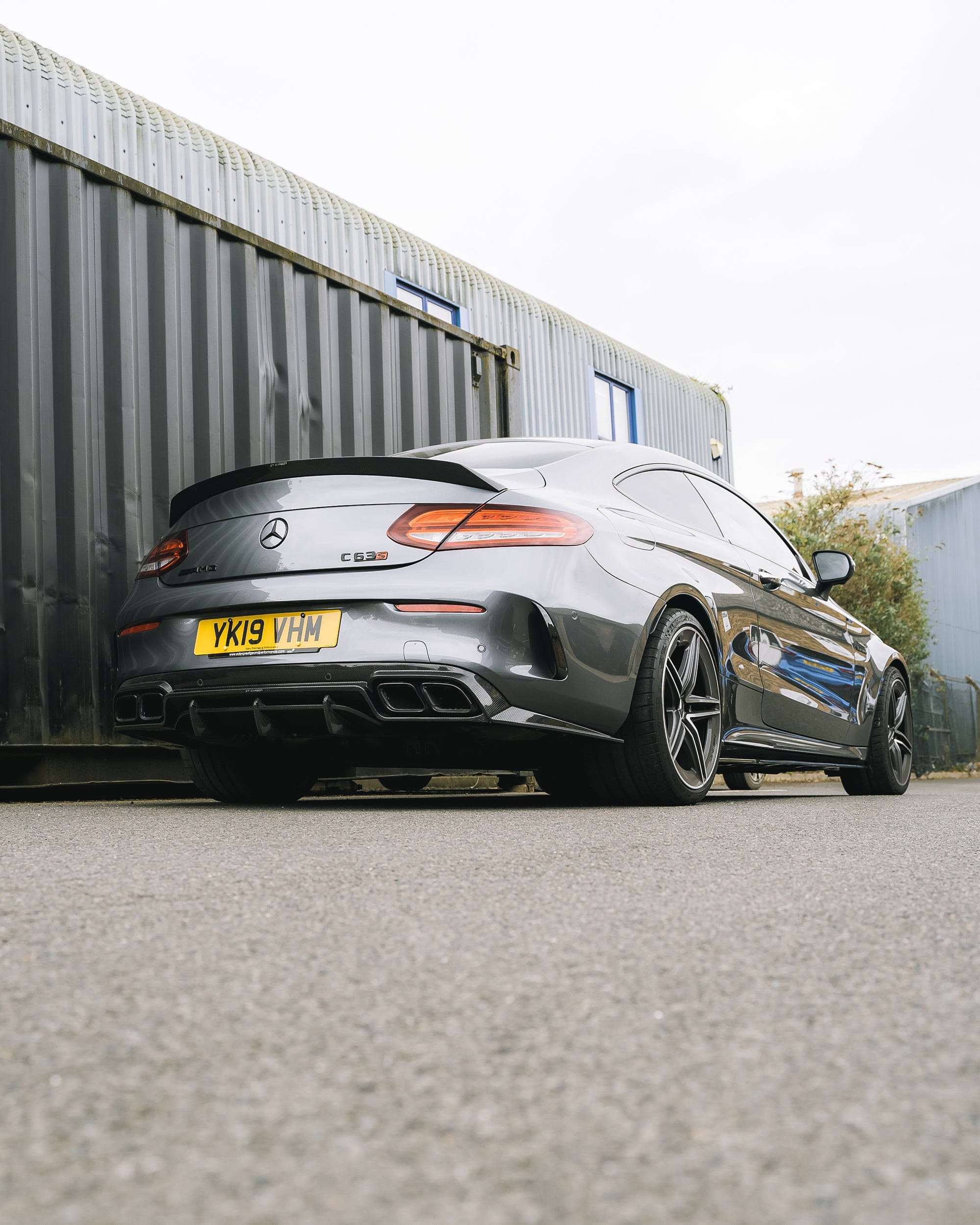 Mercedes C63/C Class W205 convertible carbon spoiler by CT Carbon, V2, showing sleek aerodynamic design on glossy black surface.
