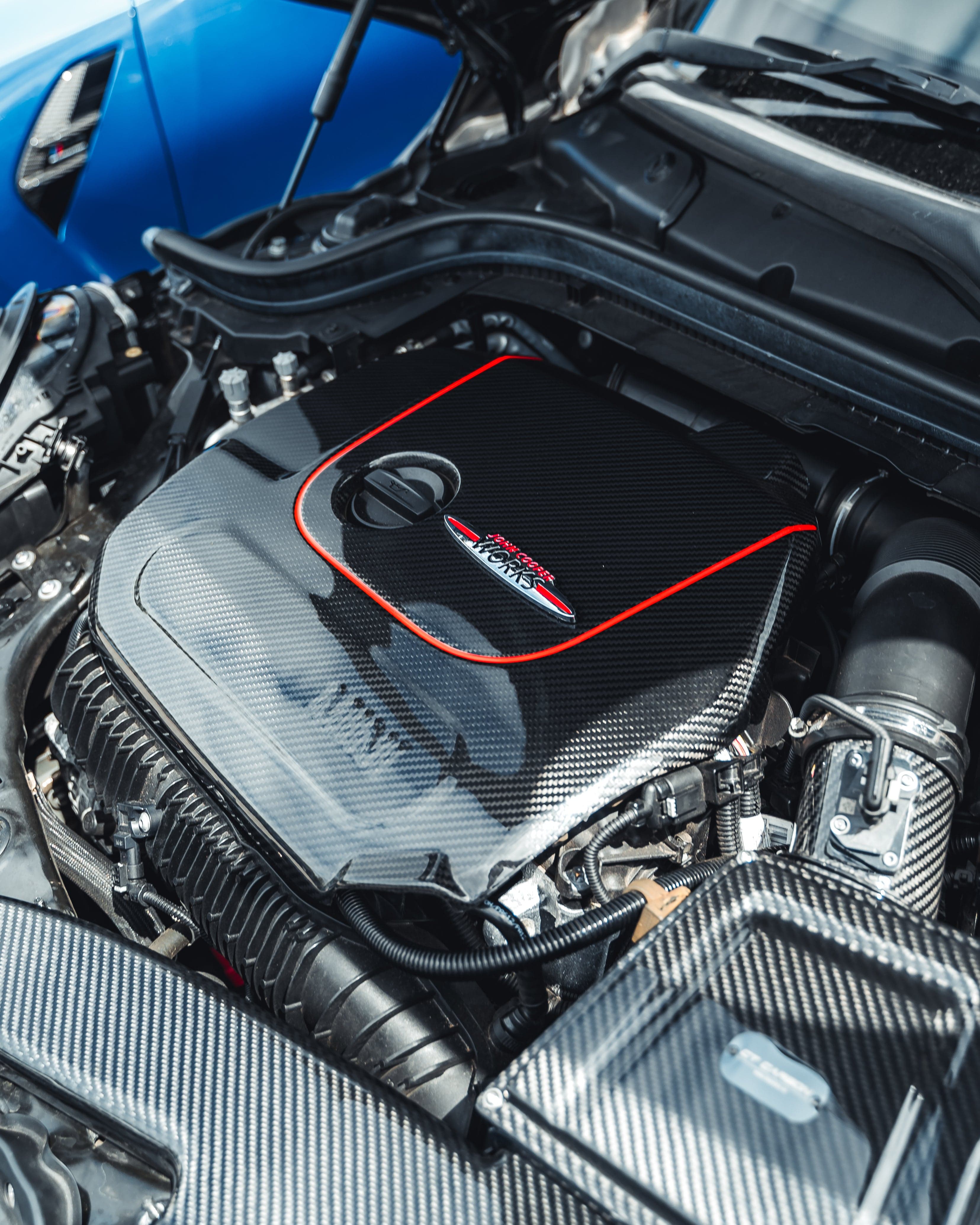 Mini Cooper S / JCW F56 carbon fiber engine cover by CT Carbon, showcasing sleek, lightweight engine protection accessory.