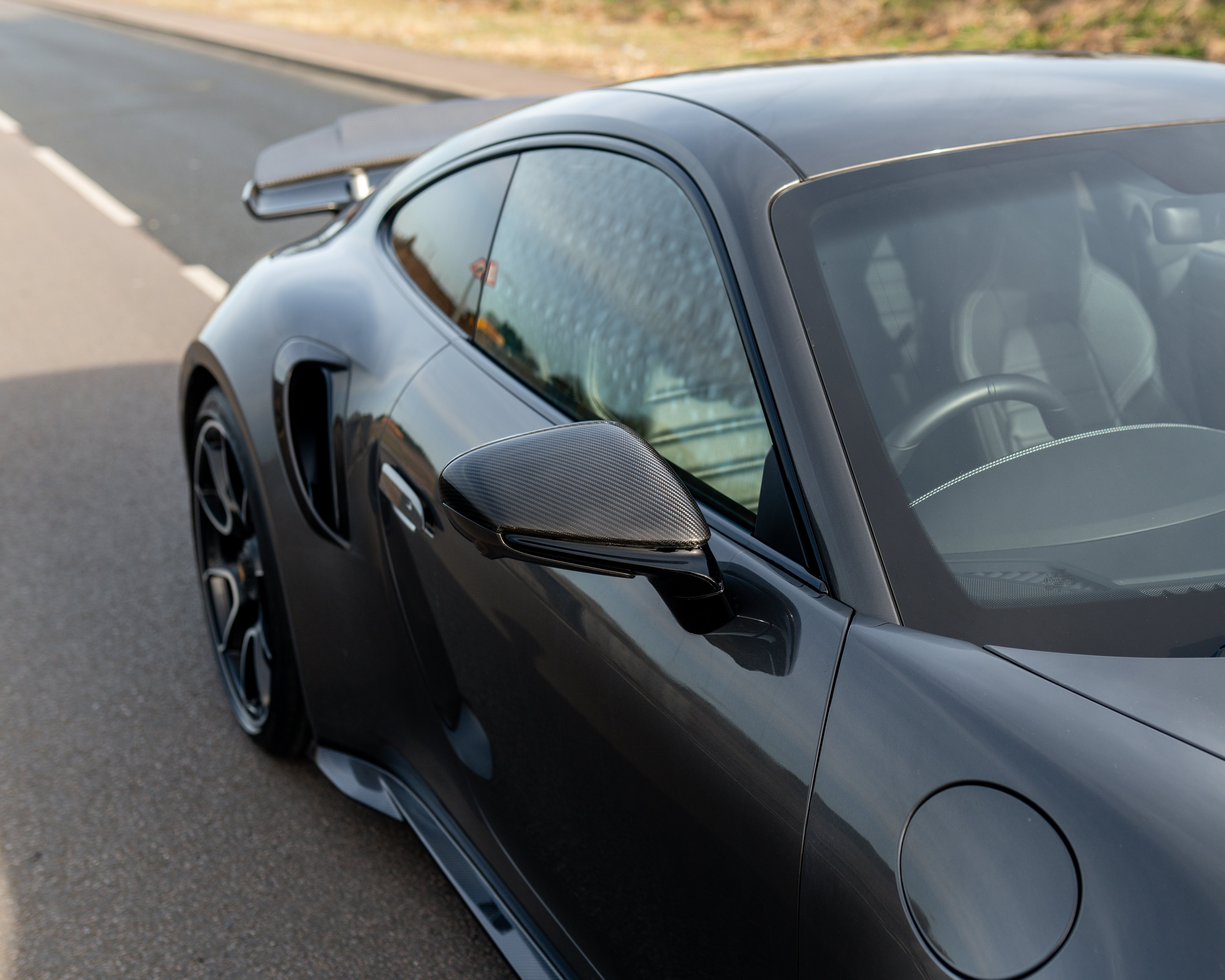 Porsche 911 992 carbon fibre side mirrors by CT Carbon, RHD only, showing sleek carbon fiber finish on each mirror.