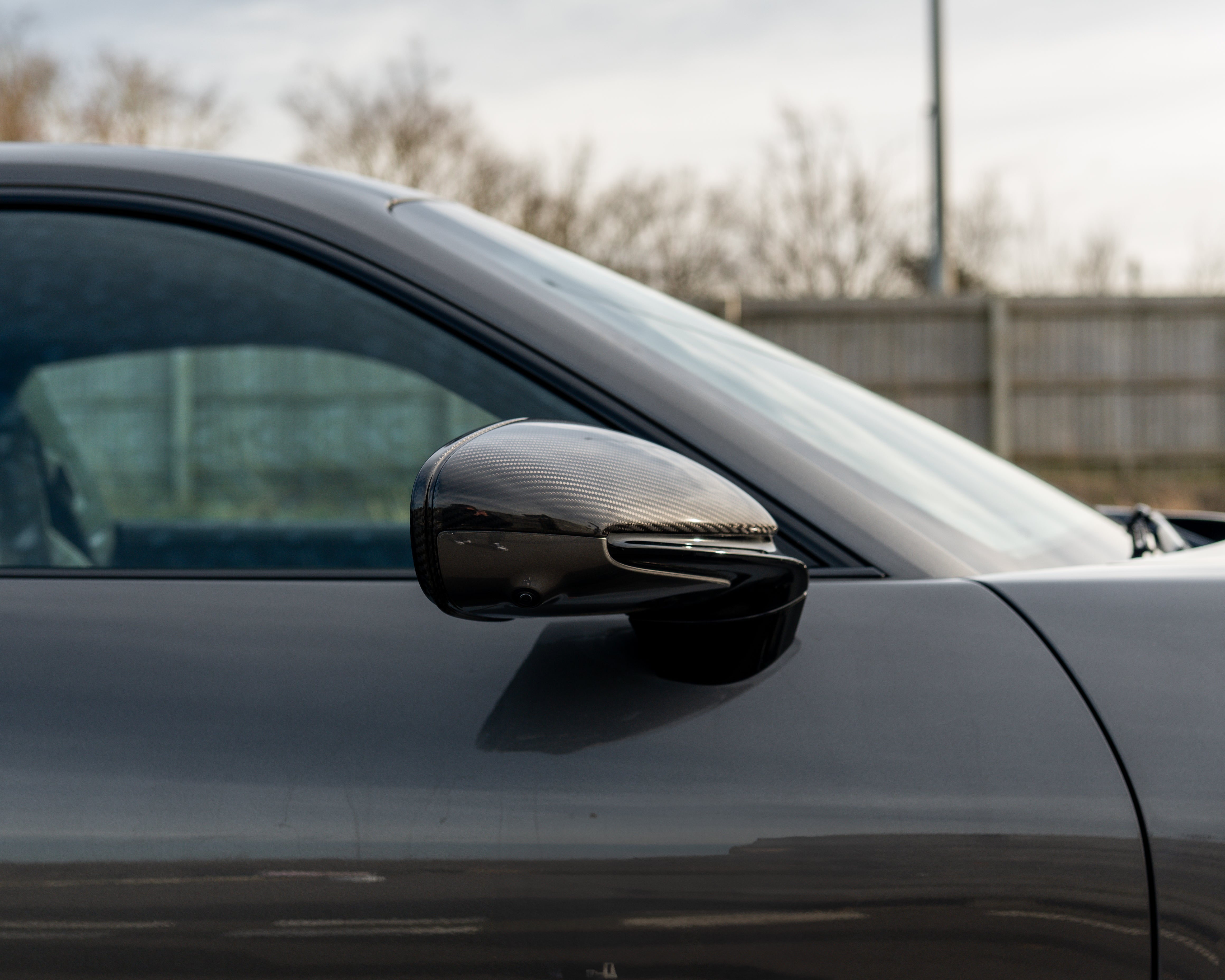 Porsche 911 992 carbon fiber side mirrors for RHD models by CT Carbon, showing sleek black finish and aerodynamic design.