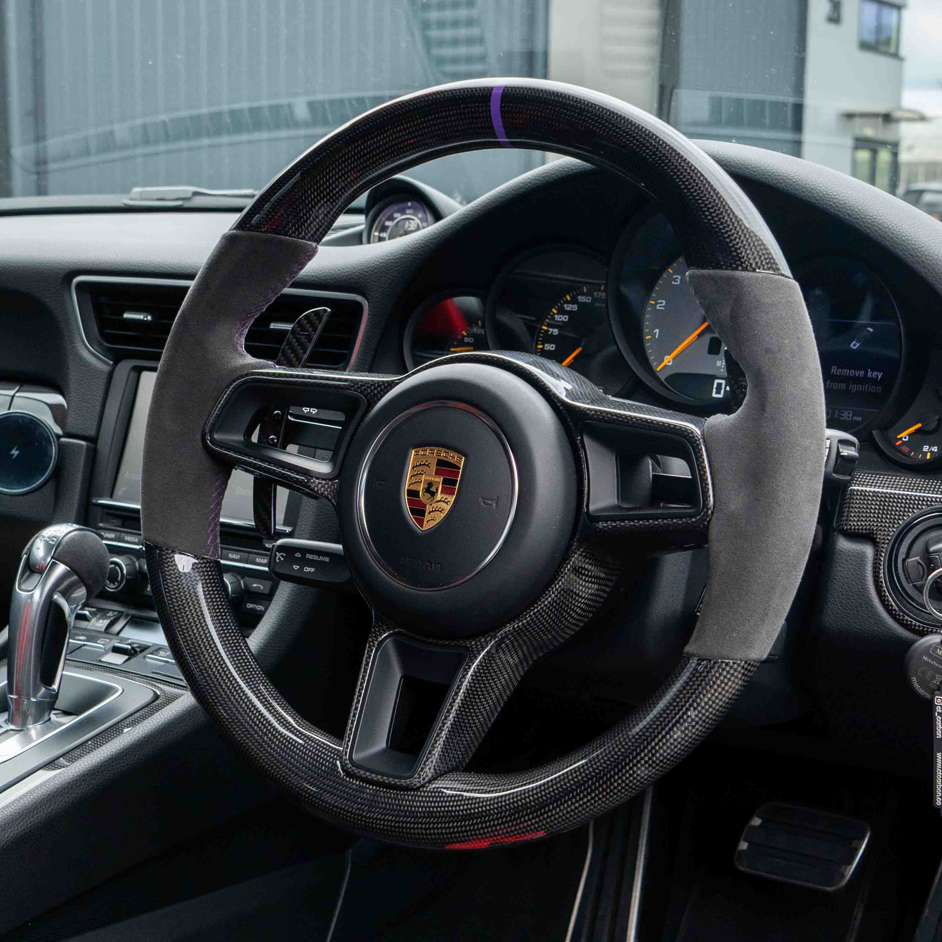 Porsche 911, Cayman, Boxster, Cayenne, Macan magnetic carbon fiber paddle shifters by CT Carbon installed in the car interior.
