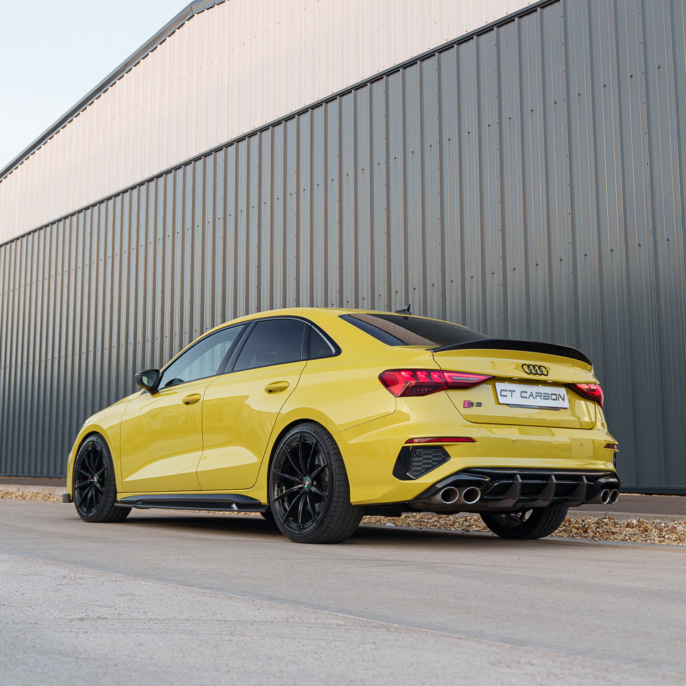 Yellow Audi S3 8Y with CT Carbon S-Line side skirts, showing the sleek carbon fiber design on the vehicle's side.