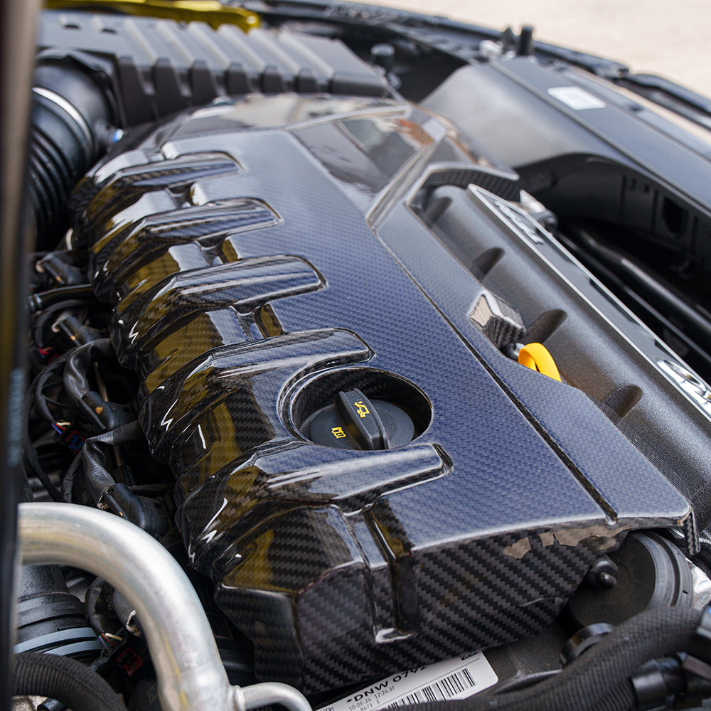 Carbon fiber engine cover kit for Audi RS3 8Y 2020+ by CT Carbon, featuring sleek, high-quality engine covers on a sporty engine bay.