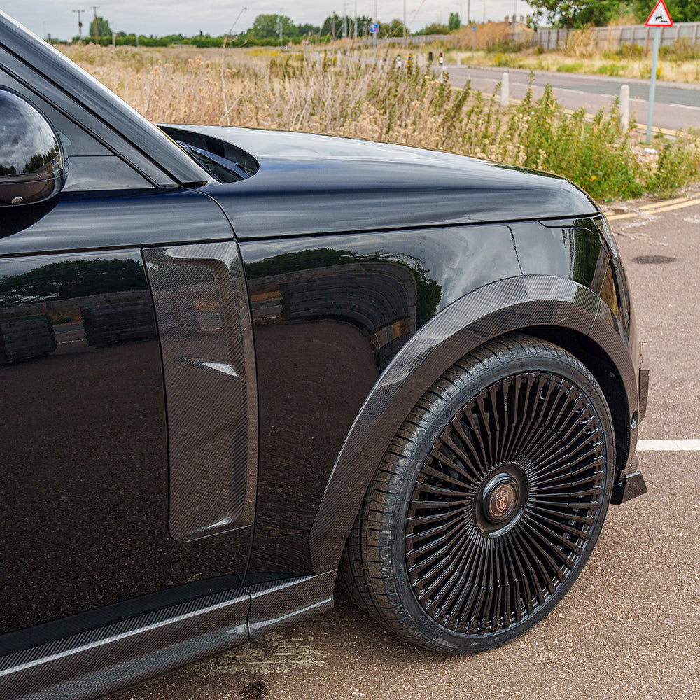 Range Rover L460 2022+ carbon fiber side door trim accessory by CT Carbon, showcasing sleek textured finish on vehicle door.