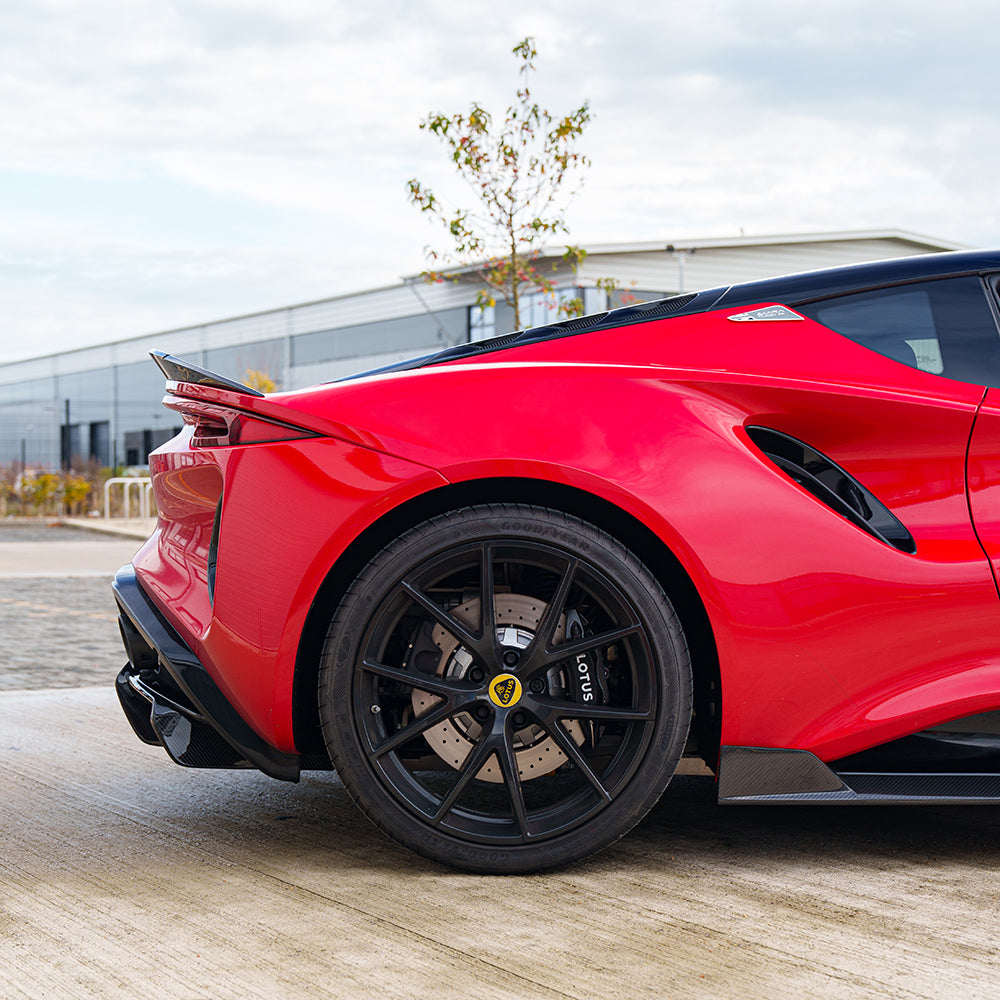 Red Lotus Emira car with CT Design carbon fibre 3-piece spoiler installed, showcasing sleek, aerodynamic automotive upgrade.