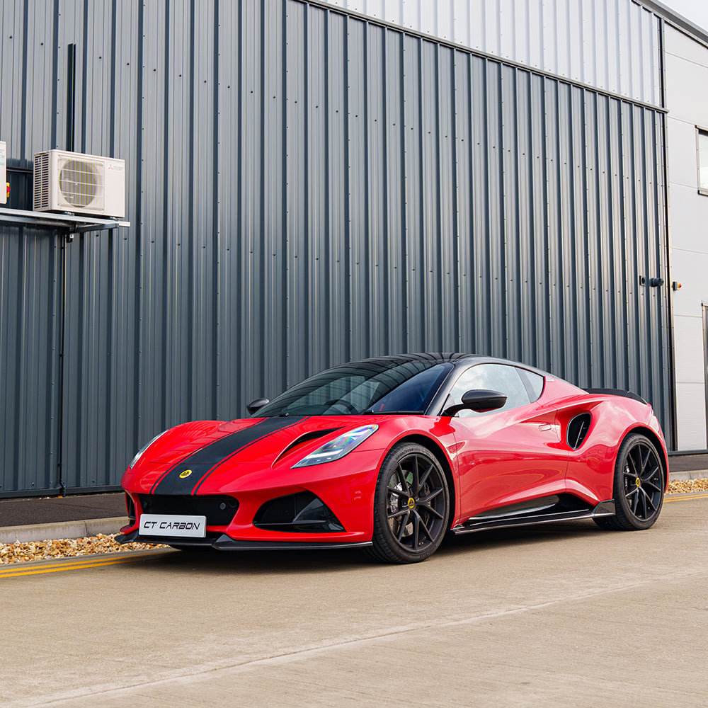 Red Lotus Emira with CT Carbon fiber side skirts, showcasing sleek, aerodynamic design and high-quality carbon fiber finish.