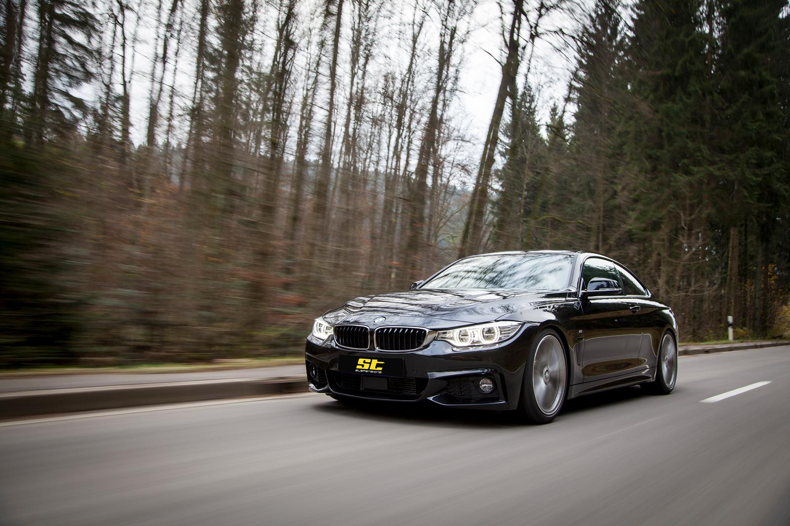 ST Suspension coilovers installed on a BMW F32 4 Series, showing adjustable shock absorbers and suspension components.