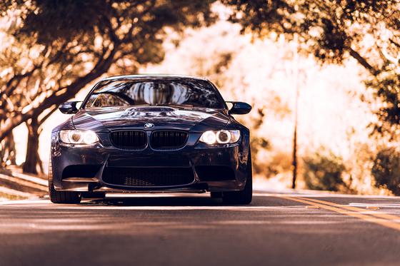 ST Suspension coilovers with adjustable damping and top mounts installed on a BMW E92 M3, showing the suspension components.