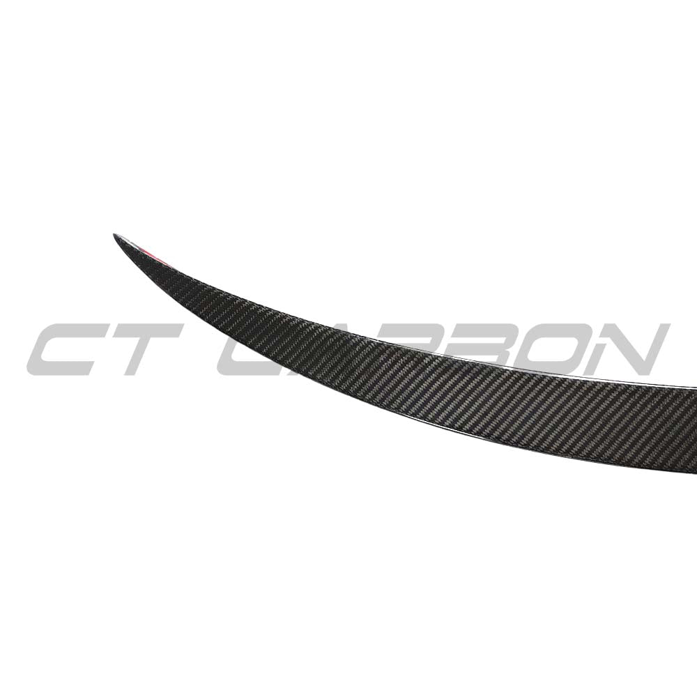 Tesla Model 3 2017-2023 carbon fiber spoiler by CT Carbon, showing the sleek V2 design mounted on the car's rear.