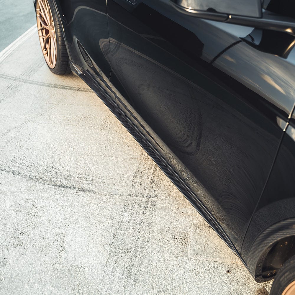 Tesla Model Y MK1 carbon fiber side skirts by CT Carbon, showcasing sleek, lightweight automotive side skirts in black carbon fiber.