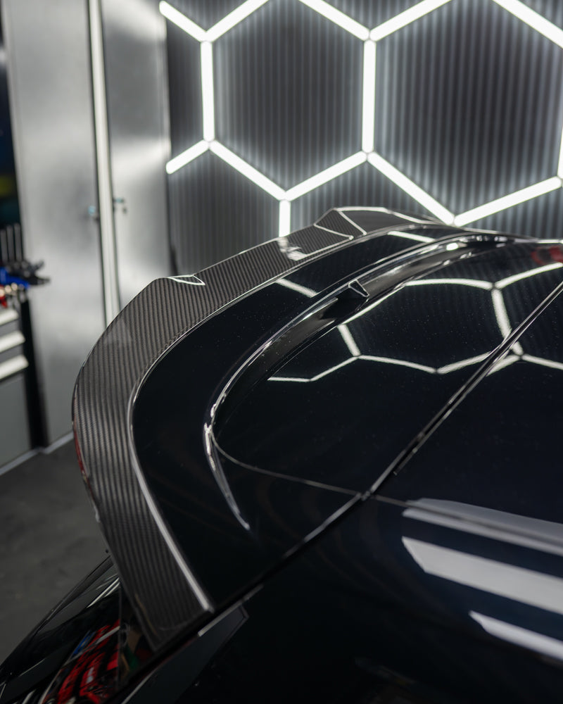 VW Golf MK8 CS carbon fibre spoiler by CT Design, shown mounted on the car's rear with a sleek, aerodynamic finish.