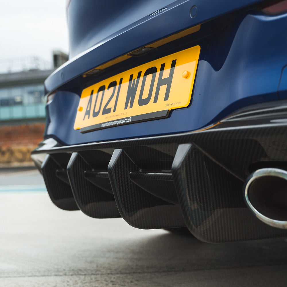Carbon fiber diffuser for VW Golf MK8/MK8.5 R 2020+ by CT Carbon, shown installed on the rear of the vehicle.