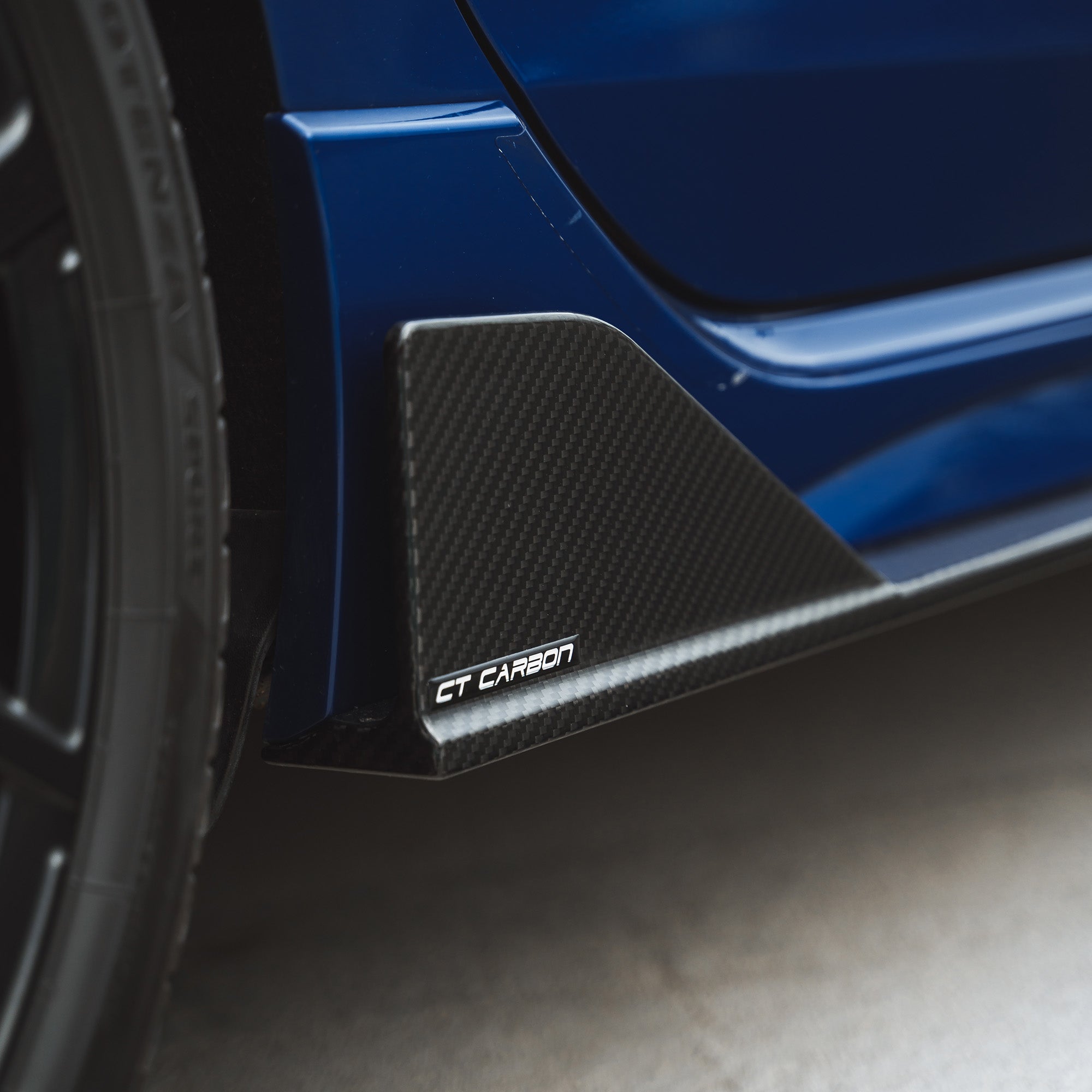 VW Golf MK8 R full carbon fibre kit by CT Carbon, showing detailed carbon fibre panels on the car's exterior.