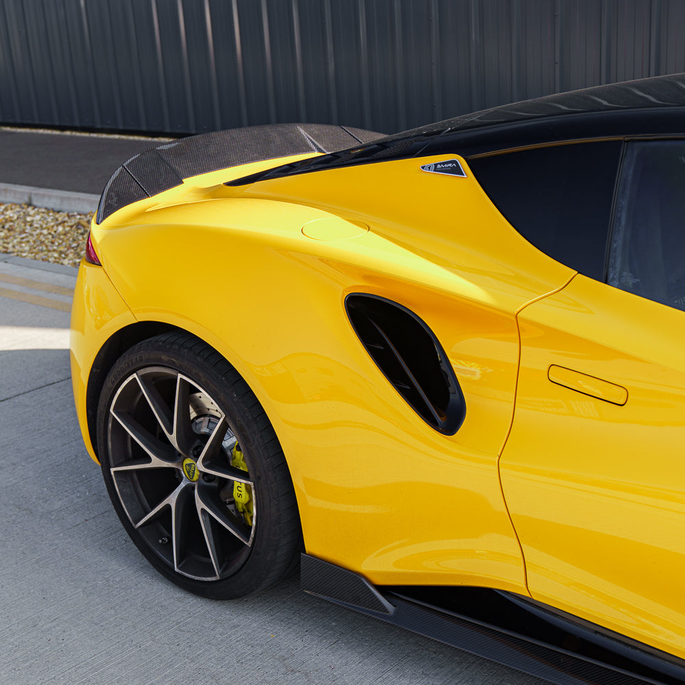 Yellow Lotus Emira with CT Carbon 3-piece carbon fibre spoiler, showcasing sleek, aerodynamic design on a sports car.