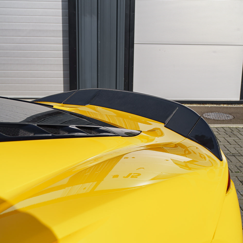 Yellow Lotus Emira car with CT Carbon 3-piece spoiler, showcasing its sleek carbon fibre design and sporty aerodynamic style.