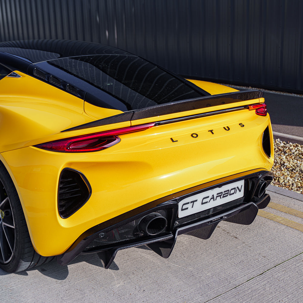 Yellow Lotus Emira with CT Carbon three-piece carbon fibre spoiler, showcasing a sleek, aerodynamic design on the car's rear.