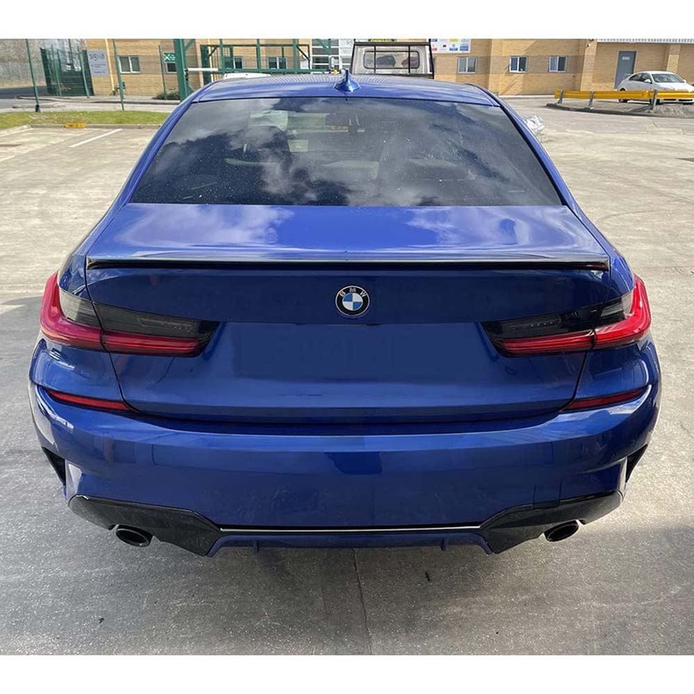 BMW 3 Series G20 gloss black full kit with square exhaust from CT Carbon, featuring round exhaust exits and V1 styling.