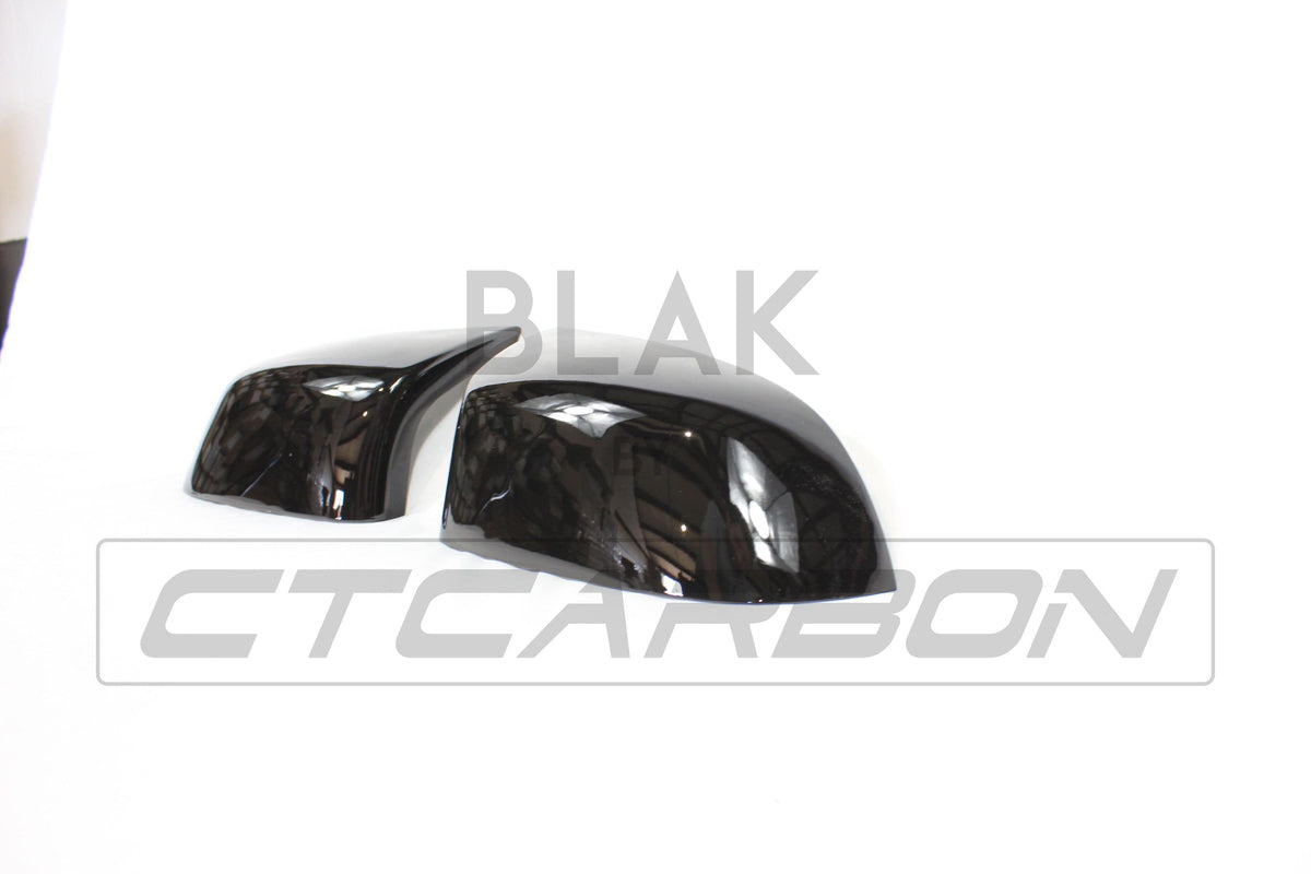 Gloss black mirror replacements for BMW F15/F16 X5/X6 by CT Carbon, showcasing sleek, reflective mirror covers on the vehicle.