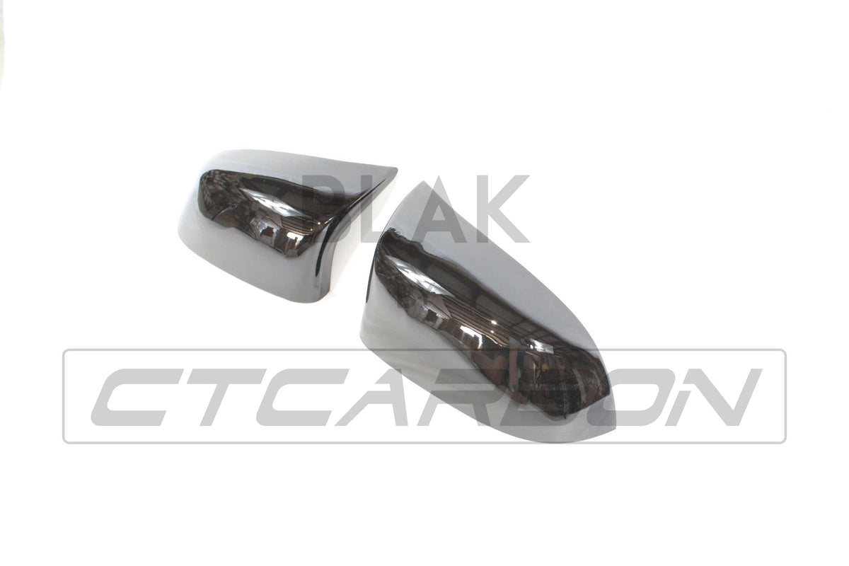 Gloss black BMW F15/F16 X5/X6 mirror replacements by CT Carbon, showcasing sleek, reflective side mirror covers for 2014-2018 models.