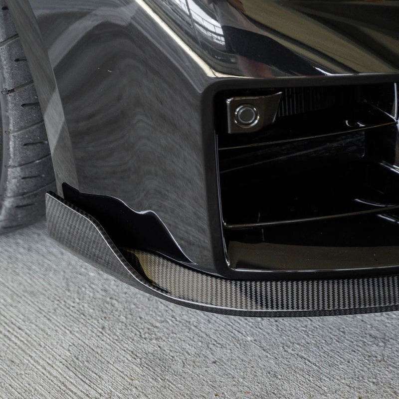 BMW G87 M2 TR87 carbon fibre front splitter with winglets by TREVORA installed on 2023 model, showcasing aerodynamic design.