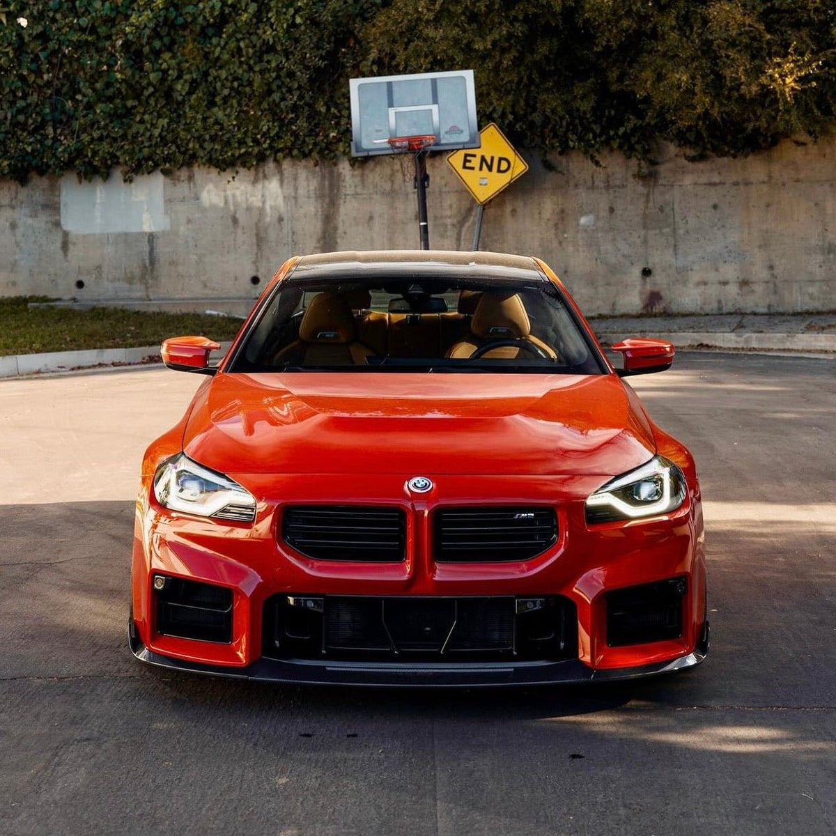 BMW G87 M2 TREVORA TR87 carbon body kit with winged carbon fiber components on a sleek sports car.