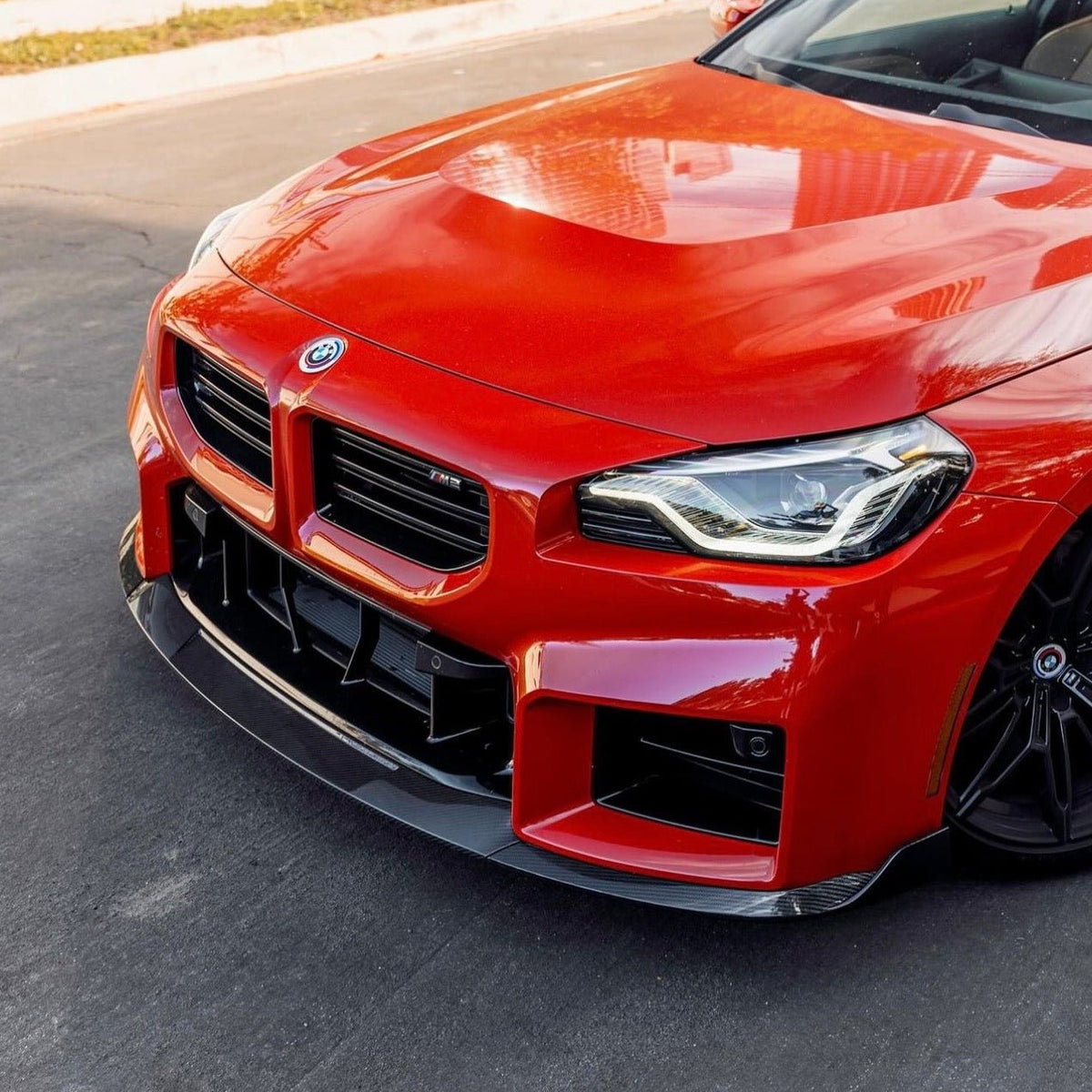 BMW G87 M2 TR87 carbon body kit by TREVORA featuring winged carbon fiber components on a sleek sports car.