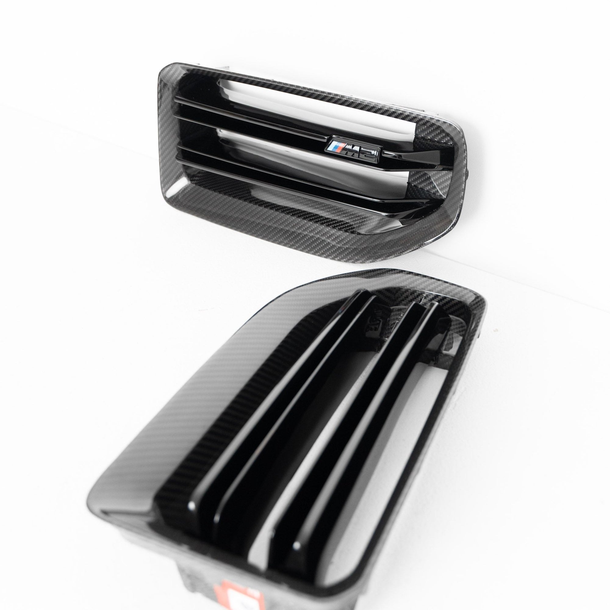 BMW M2 G87 front grille with pre-preg carbon fiber by TREVORA, showcasing sleek, lightweight design for 2023-2024 model.