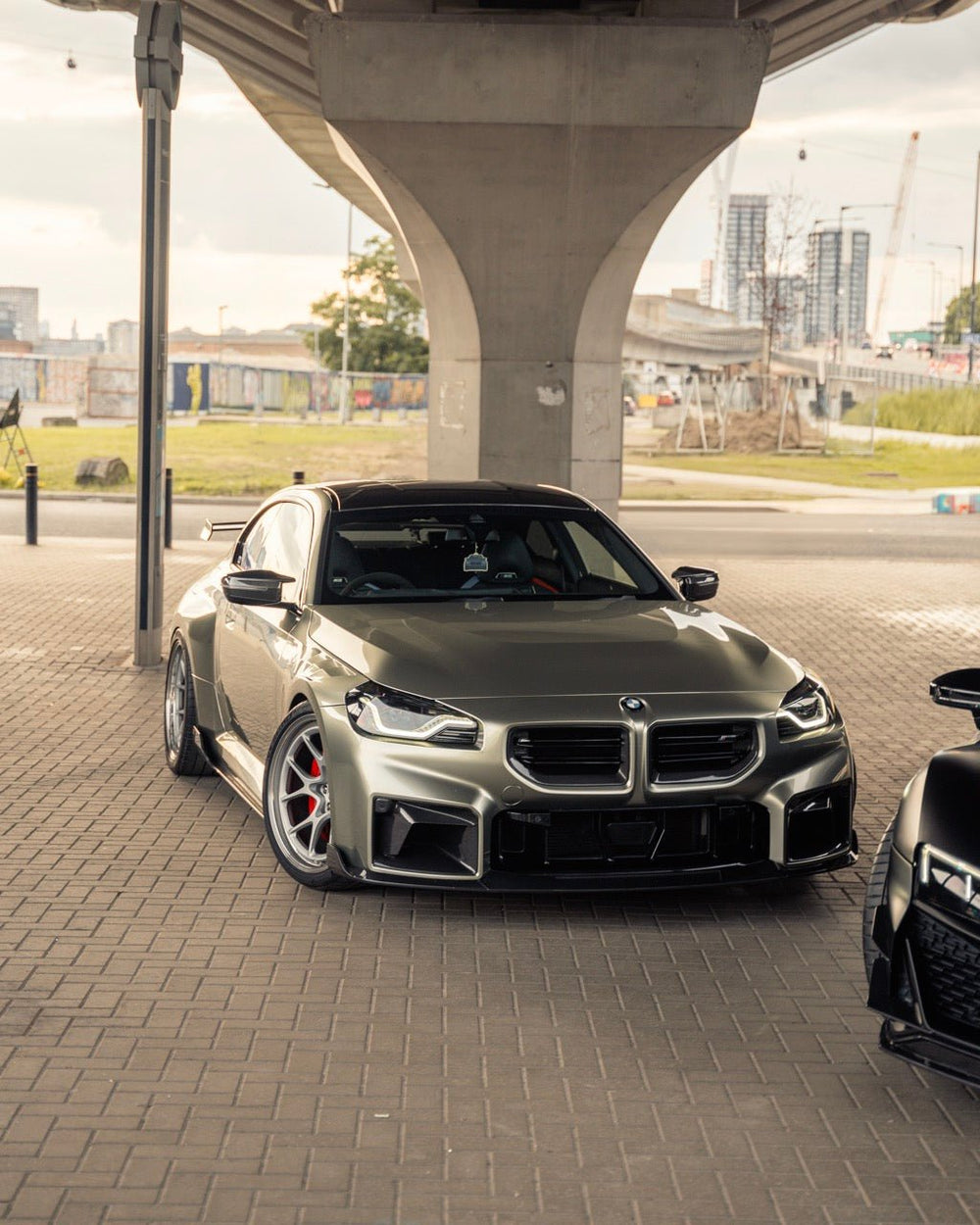 BMW M2 G87 front grille with pre-preg carbon fiber TR87 design by TREVORA, showcasing sleek, textured carbon fiber finish.