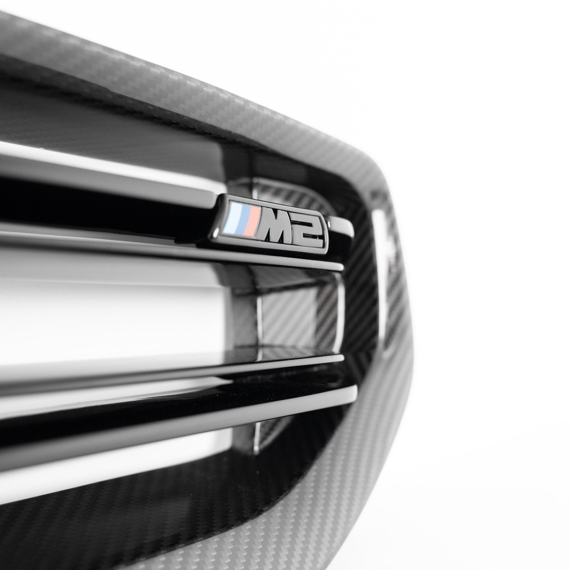 BMW M2 G87 pre-preg carbon fiber front grille by TREVORA, showcasing sleek black design and detailed mesh pattern.