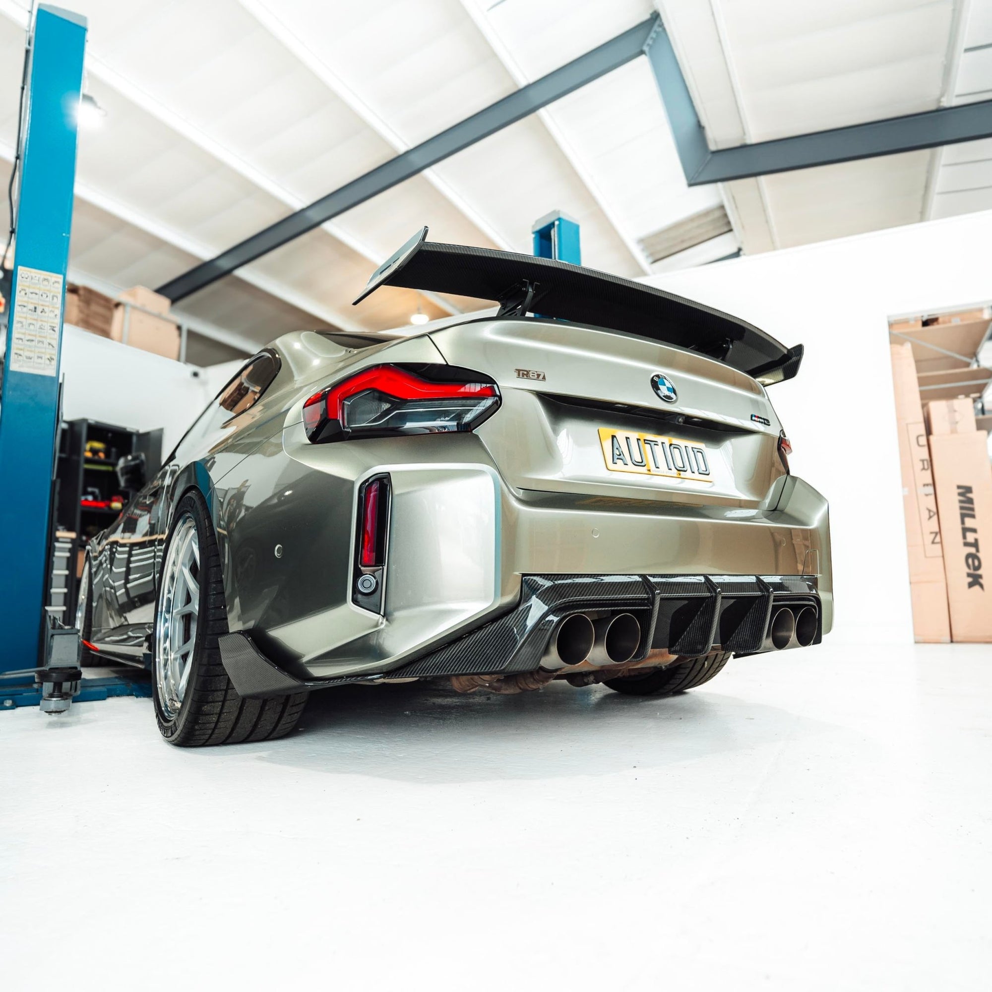 BMW M2 G87 2023 rear diffuser made of pre-preg carbon fiber by TREVORA, showcasing its sleek design and high-quality finish.