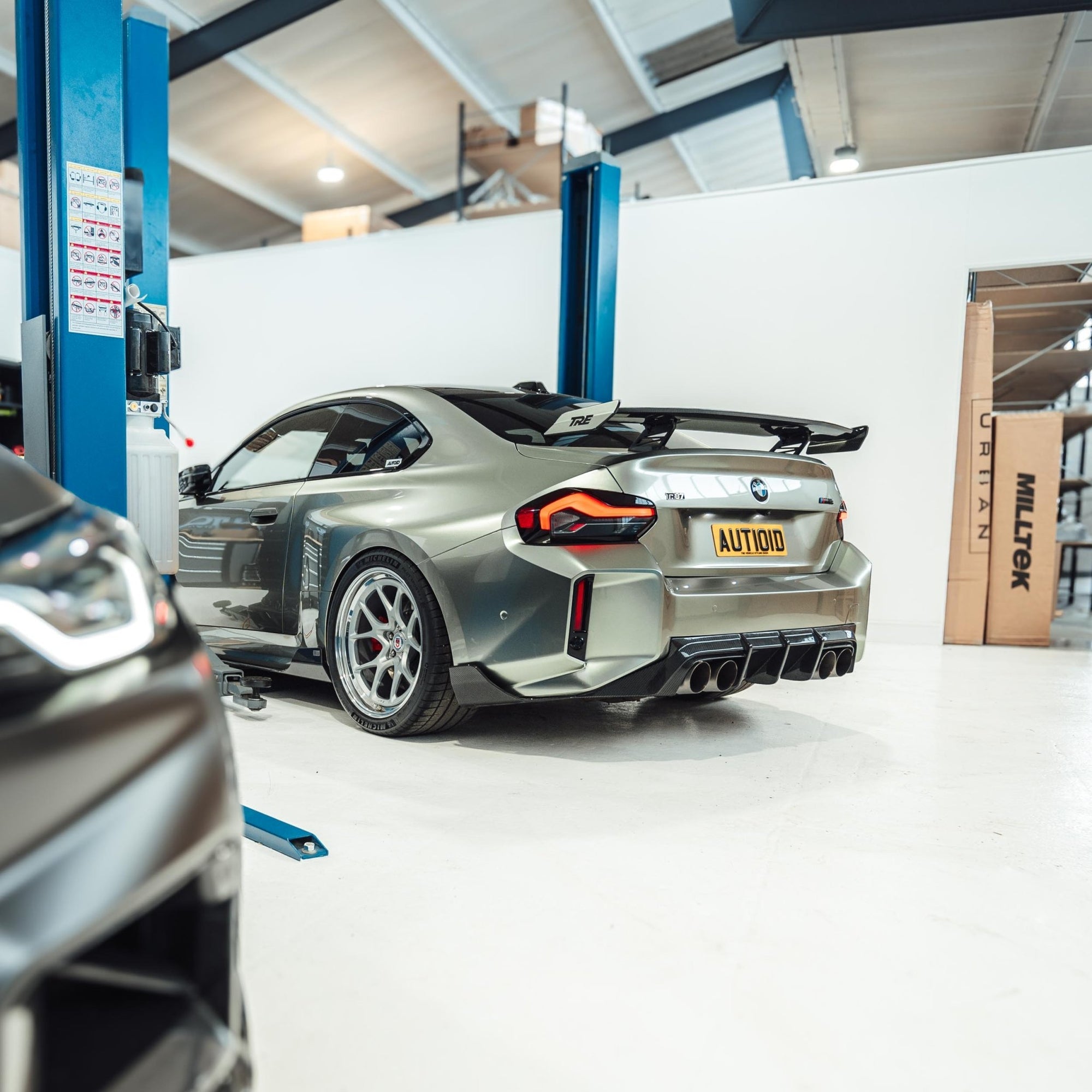 BMW M2 G87 2023 pre-preg carbon fiber TR87 rear diffuser by TREVORA, showcasing sleek aerodynamic design and high-quality craftsmanship.