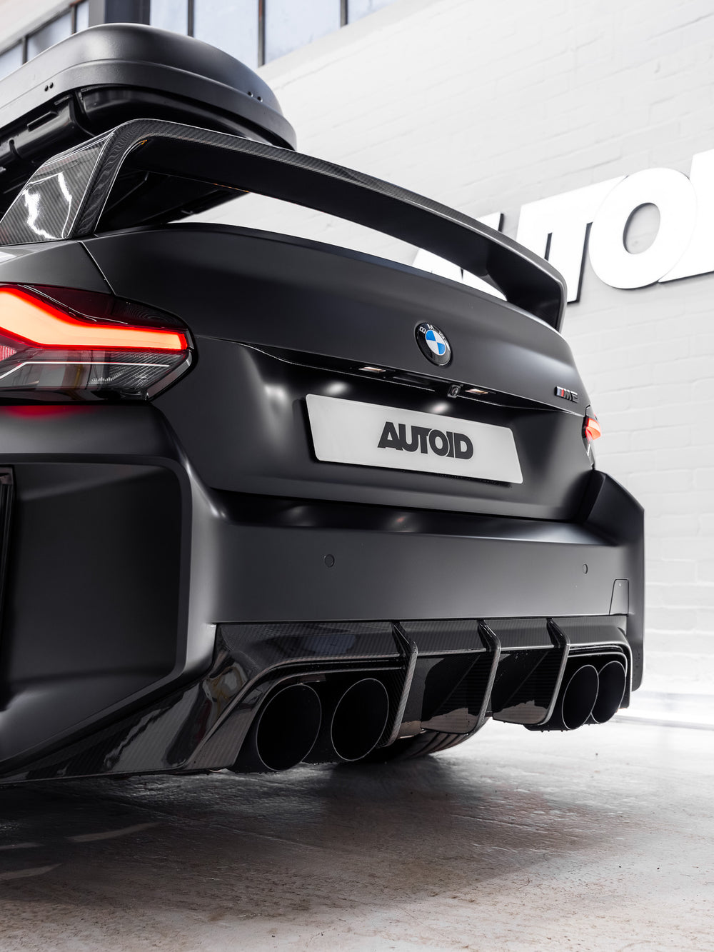 BMW M2 G87 rear diffuser made of pre-preg carbon fiber by TREVORA, showcasing its sleek design and textured finish.
