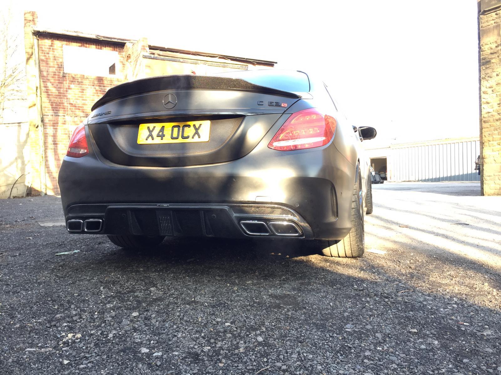 CT Carbon diffuser for Mercedes W205 C63 and C63S saloon, showcasing sleek carbon fiber design on a four-door Mercedes-Benz.
