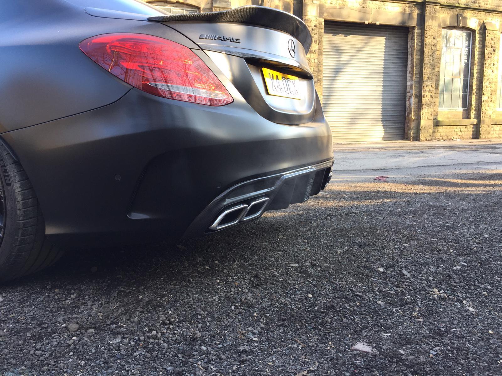 Carbon diffuser for Mercedes W205 C63 and C63S saloon, designed by CT Carbon, with sleek black carbon fiber finish.