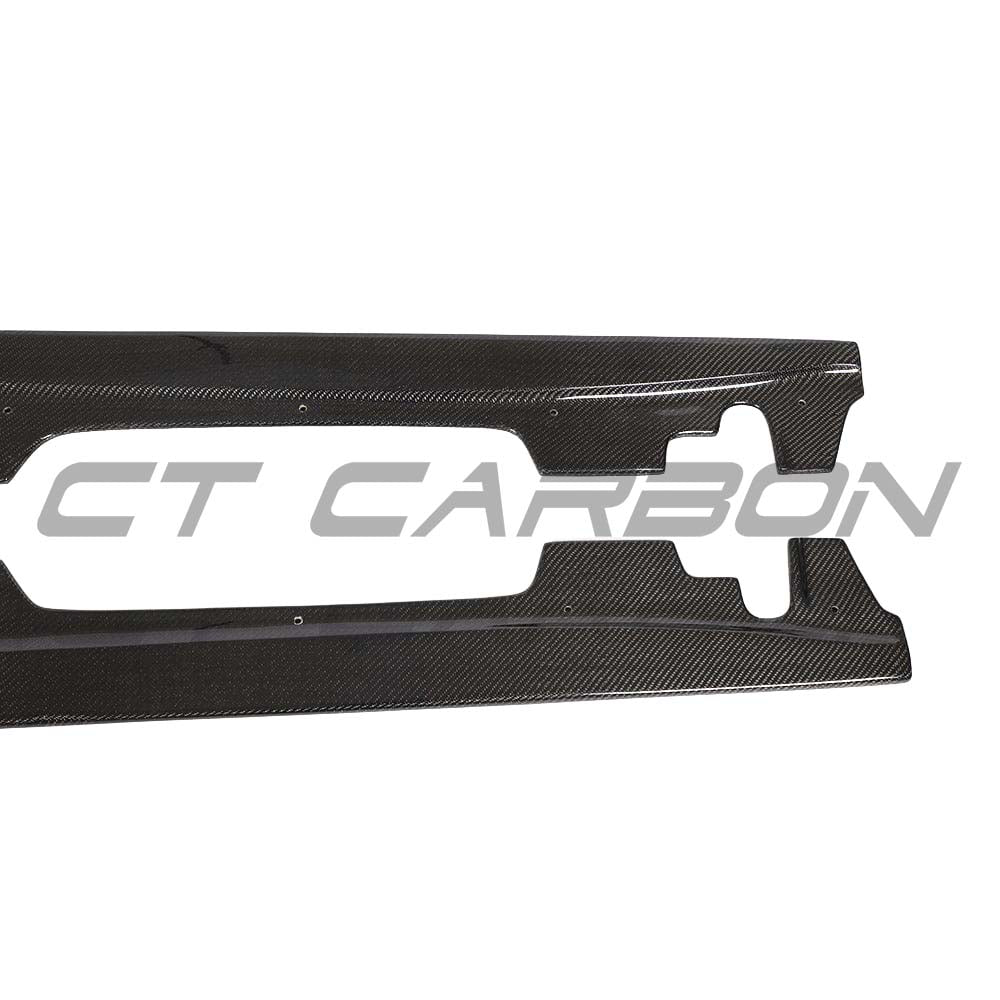 BMW M3 E92 carbon fibre side skirts by CT Carbon, showcasing sleek, lightweight automotive side skirts with textured carbon fiber finish.