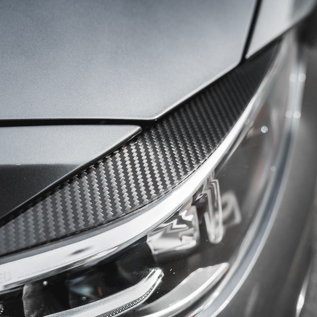 BMW M3 M4 F80 F82 F83 carbon fibre eye lids accessory by CT Carbon, close-up view showing sleek, lightweight carbon fibre design.
