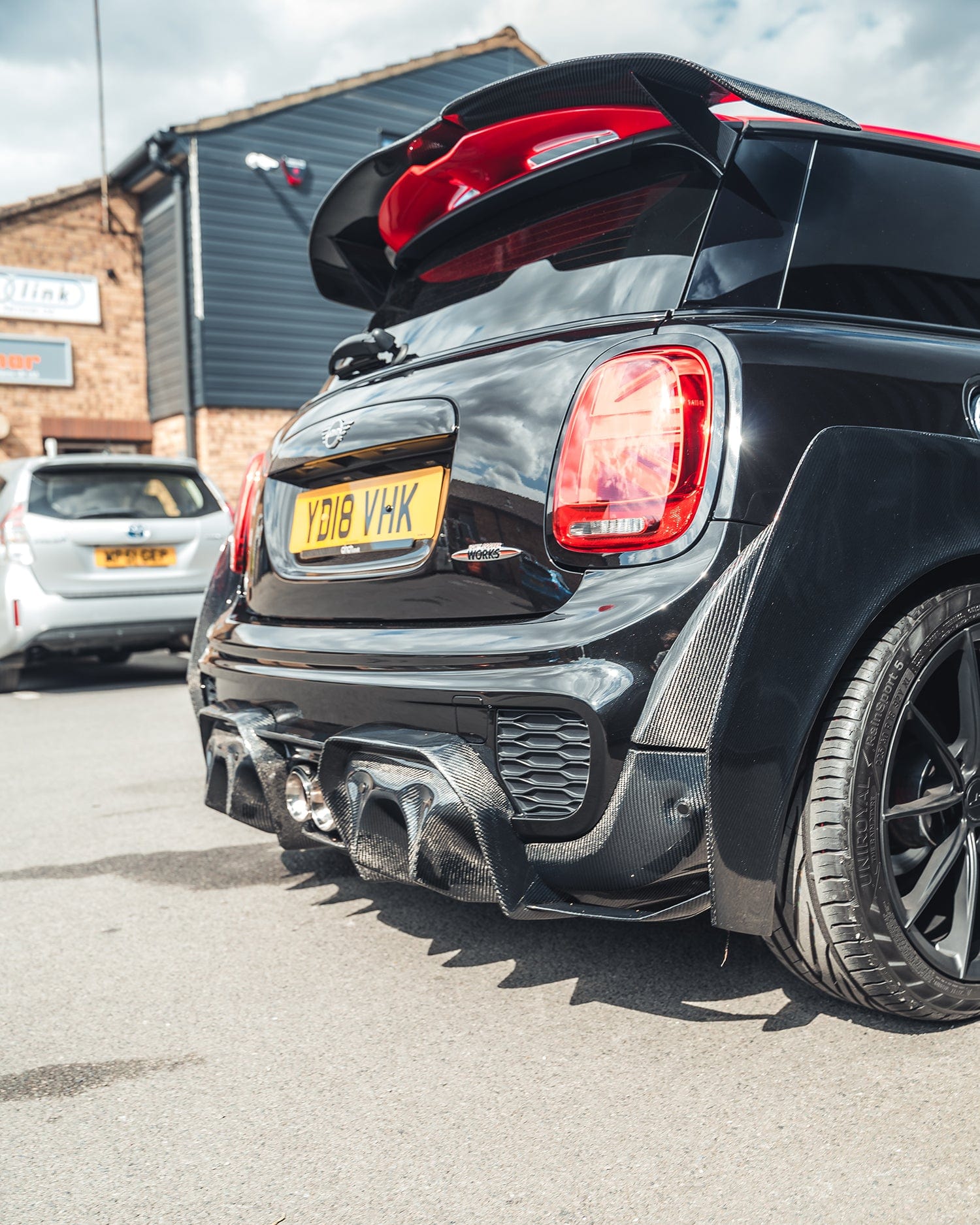 Carbon fiber spoiler for Mini Cooper S F56/JCW Sport Pack by CT Carbon, showcasing sleek, aerodynamic design on the vehicle.