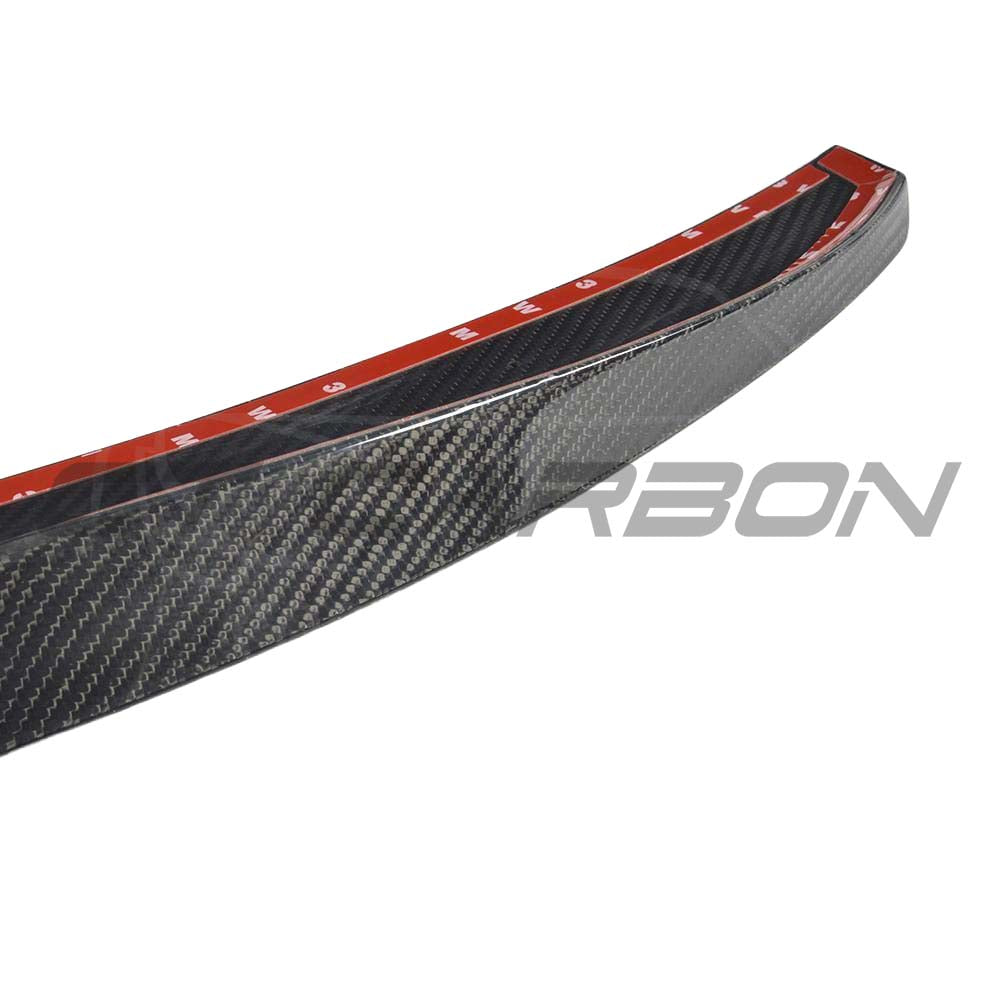 BMW G30 5 Series 2016-2023 carbon fibre kit featuring M4-style spoiler by CT Carbon, showcasing sleek carbon fibre finish.