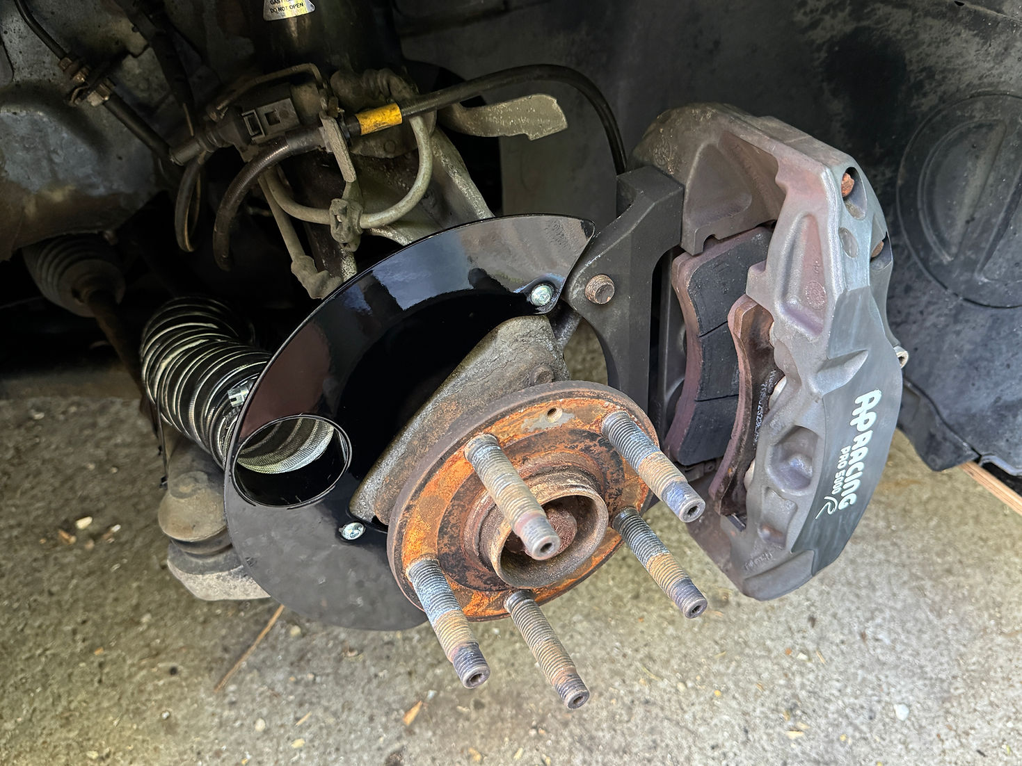 Sprogley Motorsport lower control arm brake cooling kit with ducts for MQB and MQB EVO vehicles, showing the black metal ducts and mounting points.