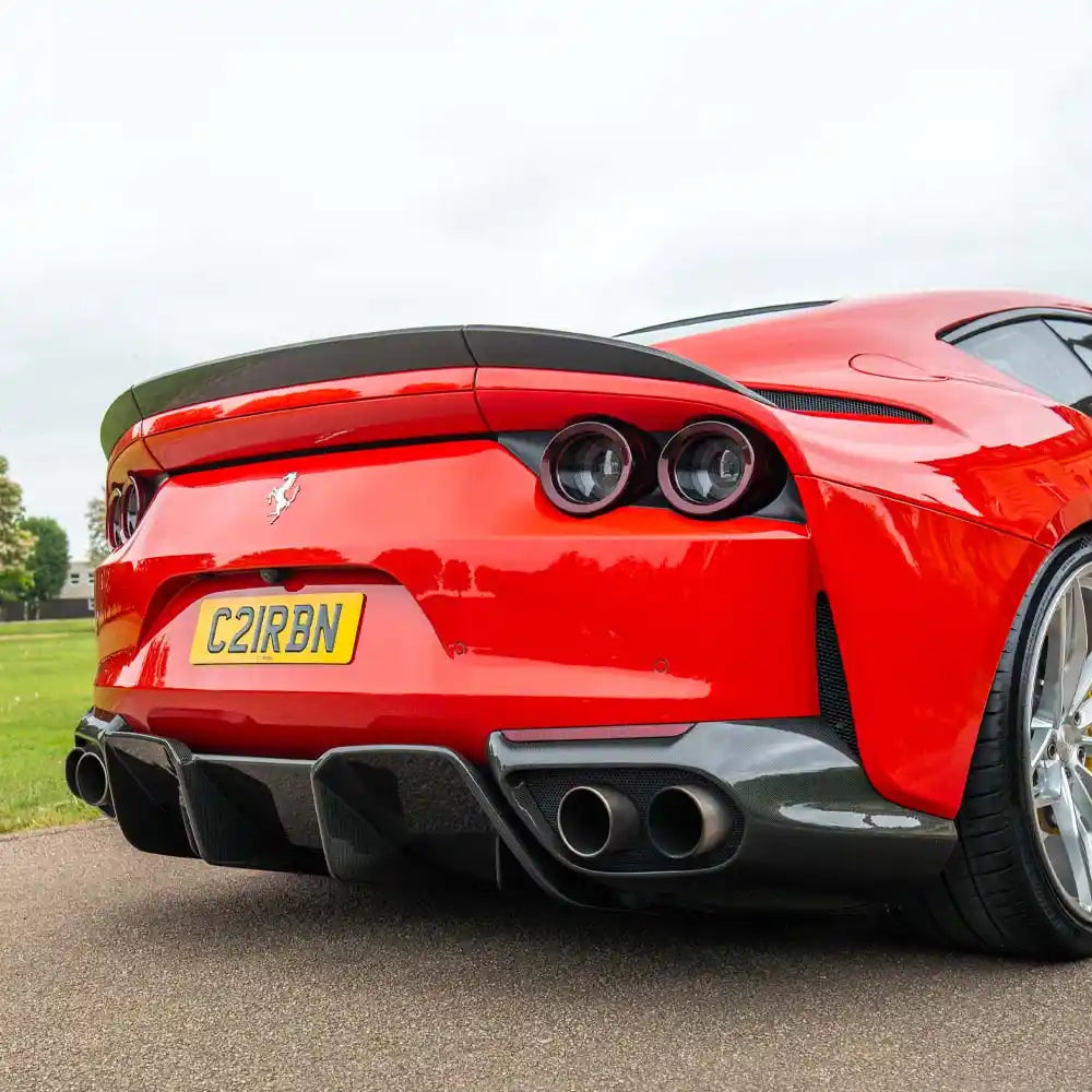 Carbon fiber diffuser for Ferrari 812 Superfast by CT Carbon, showcasing sleek, lightweight design and intricate fiber weave.